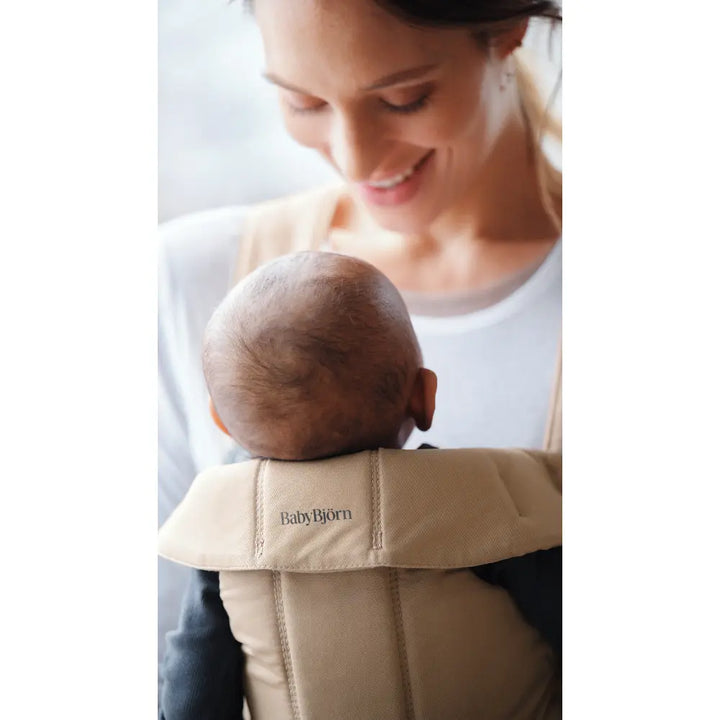BabyBjorn Mini Baby Carrier, Soft &amp; Lightweight Fabric, 3 Carrying Positions, Ergonomic Hip and Head Support, Adjustable Waistbelt &amp; Cross Straps, Easy to Use, Birth to 12 Months (upto 11kg) - Beige