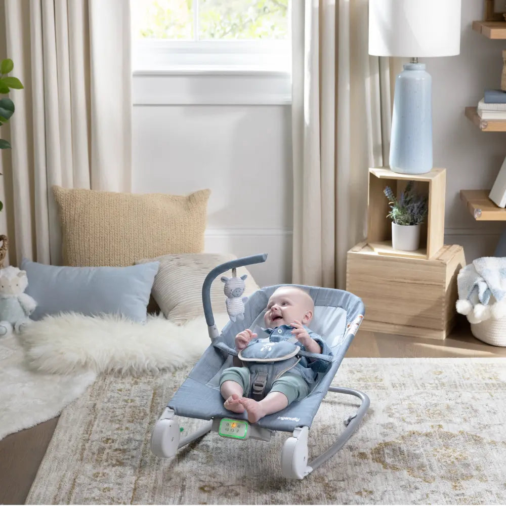 Ingenuity Happy Belly Rock-to-Bounce Baby Massage Seat with Soothing Vibrations, Music &amp; Belly Massage Technology, 0-6 months,  Chambray